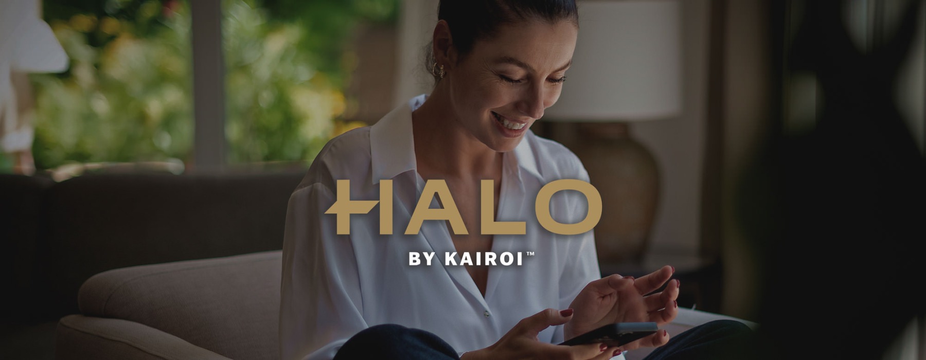 a woman smiling and interacting with her device