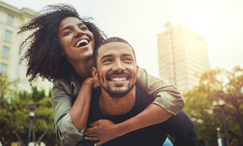 a couple laughing outdoors